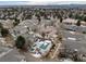Bird's eye view of community showing townhomes, a shared pool area, landscaping, and surrounding area at 8621 E Dry Creek Rd # 325, Englewood, CO 80112