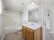 Simple bathroom with a wood vanity, single sink, and a bathtub/shower combo at 8621 E Dry Creek Rd # 325, Englewood, CO 80112