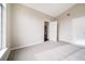Neutral bedroom with vaulted ceiling, large window, and bright white doors at 8621 E Dry Creek Rd # 325, Englewood, CO 80112
