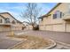 Townhome complex featuring assigned garages, ample parking, and well-maintained landscaping at 8621 E Dry Creek Rd # 325, Englewood, CO 80112