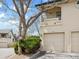 Exterior shot with a two-car garage and landscaping in front at 8621 E Dry Creek Rd # 325, Englewood, CO 80112