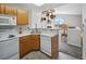 Bright kitchen with white appliances and a view into the living room at 8621 E Dry Creek Rd # 325, Englewood, CO 80112