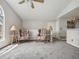Carpeted living area with floral chairs, lamps, ceiling fan, and partial view of kitchen at 8621 E Dry Creek Rd # 325, Englewood, CO 80112