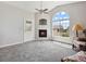 Bright living room boasts vaulted ceilings, a cozy fireplace, and a large window at 8621 E Dry Creek Rd # 325, Englewood, CO 80112