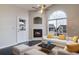 Bright living room featuring vaulted ceiling, fireplace and large arched windows at 8621 E Dry Creek Rd # 325, Englewood, CO 80112
