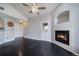 Open-concept living room with fireplace and dark, sleek hardwood flooring at 8621 E Dry Creek Rd # 325, Englewood, CO 80112