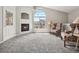 Bright living room boasts vaulted ceilings, a cozy fireplace, and a large window at 8621 E Dry Creek Rd # 325, Englewood, CO 80112