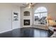 Cozy living room featuring vaulted ceiling, fireplace and large arched windows at 8621 E Dry Creek Rd # 325, Englewood, CO 80112
