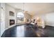 Spacious living area featuring fireplace, large arched window and vaulted ceiling at 8621 E Dry Creek Rd # 325, Englewood, CO 80112