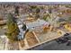 Aerial view of a well-maintained home with mature trees, a manicured lawn, and convenient street access at 11845 W 30Th Pl, Lakewood, CO 80215