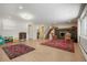 Finished basement featuring a fireplace, stairs leading to the upper level, and a decorative rug at 11845 W 30Th Pl, Lakewood, CO 80215