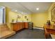 Cozy basement bar featuring wooden cabinets, granite counters, stainless mini-fridge, and tiled flooring at 11845 W 30Th Pl, Lakewood, CO 80215