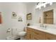 Charming bathroom with a modern vanity, a large mirror, and neutral fixtures at 11845 W 30Th Pl, Lakewood, CO 80215