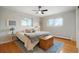 Bright bedroom featuring hardwood floors, ceiling fan, and a cozy bed with stylish decor at 11845 W 30Th Pl, Lakewood, CO 80215