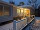 Cozy covered front porch of a home with chairs, lighting, and a snow-covered railing at 11845 W 30Th Pl, Lakewood, CO 80215