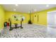 Bright home gym featuring weightlifting equipment, mirrored wall, and durable flooring at 11845 W 30Th Pl, Lakewood, CO 80215