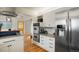 Modern kitchen with stainless steel appliances, marble countertops, and hardwood floors at 11845 W 30Th Pl, Lakewood, CO 80215