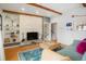 Inviting living room with a stacked stone fireplace, exposed beams, and stylish decor at 11845 W 30Th Pl, Lakewood, CO 80215