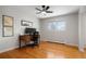 Office with hardwood floors, a ceiling fan, a window with natural light, and a wooden desk with a computer at 11845 W 30Th Pl, Lakewood, CO 80215