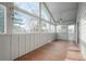 Spacious sunroom with brick tile flooring and large windows at 11845 W 30Th Pl, Lakewood, CO 80215