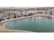 Stunning aerial view of lakeside condos with mature trees, a walking path, and easy access to the main road at 10290 W Jewell Ave # B, Lakewood, CO 80232