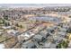 Aerial community view showcasing houses and a serene lake with lush trees at 10290 W Jewell Ave # B, Lakewood, CO 80232
