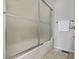 Bathroom featuring a shower and tub combination with sliding glass doors at 10290 W Jewell Ave # B, Lakewood, CO 80232