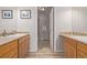 Hall bathroom with dual vanities and a shower and neutral color palette at 10290 W Jewell Ave # B, Lakewood, CO 80232
