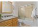 Bathroom with a wooden vanity, countertop, and a shower-tub combination at 10290 W Jewell Ave # B, Lakewood, CO 80232
