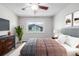 Charming bedroom featuring a ceiling fan, comfortable bedding, and a view from the window at 10290 W Jewell Ave # B, Lakewood, CO 80232