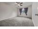 Spacious bedroom with plush carpet, a ceiling fan, and a bright window at 10290 W Jewell Ave # B, Lakewood, CO 80232