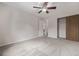 Carpeted bedroom with a closet and ceiling fan, providing ample space and storage at 10290 W Jewell Ave # B, Lakewood, CO 80232