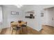 Charming dining area with wainscoting, hardwood floors, and an open view to the kitchen, perfect for Gathering meals at 10290 W Jewell Ave # B, Lakewood, CO 80232