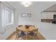 Bright dining room featuring hardwood floors, wainscoting, and a view into the adjacent kitchen at 10290 W Jewell Ave # B, Lakewood, CO 80232