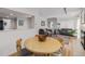 Open-concept dining area with hardwood floors, wainscoting, and a view into the living room at 10290 W Jewell Ave # B, Lakewood, CO 80232