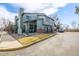 Exterior view of townhomes with garages and parking, landscaped for curb appeal at 10290 W Jewell Ave # B, Lakewood, CO 80232
