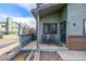 Inviting porch with two chairs and neutral gravel, complete with brick accents by the front door at 10290 W Jewell Ave # B, Lakewood, CO 80232