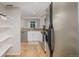 View of updated kitchen from pantry, featuring stainless steel appliances and plenty of storage at 10290 W Jewell Ave # B, Lakewood, CO 80232