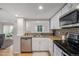 Bright kitchen features granite countertops, white cabinets, stainless steel appliances, and stylish backsplash at 10290 W Jewell Ave # B, Lakewood, CO 80232