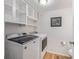 Functional laundry room with a toilet, built-in storage, and modern washer and dryer at 10290 W Jewell Ave # B, Lakewood, CO 80232