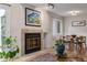 Bright living room with hardwood floors, fireplace, dining area, and modern lighting fixtures at 10290 W Jewell Ave # B, Lakewood, CO 80232