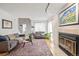 Inviting living room with a fireplace, hardwood floors, and two sofas at 10290 W Jewell Ave # B, Lakewood, CO 80232