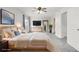 A spacious primary bedroom is virtually staged with a fan and new carpet at 10290 W Jewell Ave # B, Lakewood, CO 80232