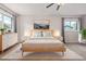 Spacious primary bedroom with two large windows, modern furniture, and plush carpet at 10290 W Jewell Ave # B, Lakewood, CO 80232