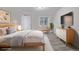 Well-lit main bedroom with a bed, dresser, and window, creating a cozy retreat at 10290 W Jewell Ave # B, Lakewood, CO 80232