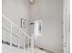 Bright entryway featuring a staircase, large window with sheer curtain, and modern lighting at 10290 W Jewell Ave # B, Lakewood, CO 80232