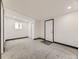 Neutral bedroom with carpeted floors, closet, a door to the exterior, and a large window at 655 S Osceola St, Denver, CO 80219