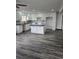 Bright kitchen features modern white cabinets, gray subway tile backsplash, and a spacious center island at 655 S Osceola St, Denver, CO 80219