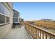 Back deck with a grill and railing overlooking the yard at 140 Racer St, Bennett, CO 80102