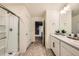 Bathroom with glass enclosed shower and double vanity at 140 Racer St, Bennett, CO 80102